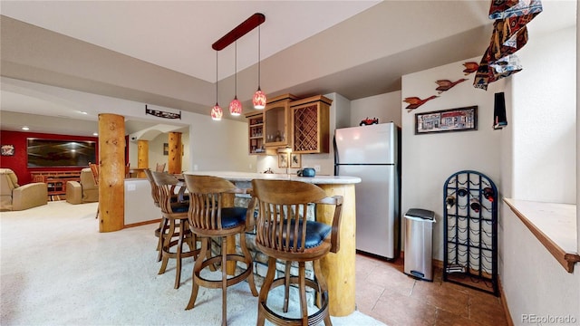 dining space with bar with sink and vaulted ceiling