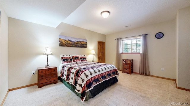 bedroom featuring light carpet and baseboards