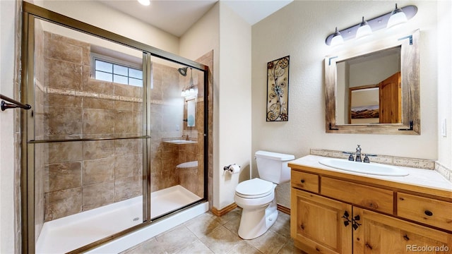 full bathroom with a stall shower, toilet, tile patterned floors, and vanity