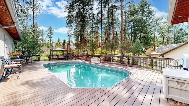 view of swimming pool featuring a deck and outdoor dining space