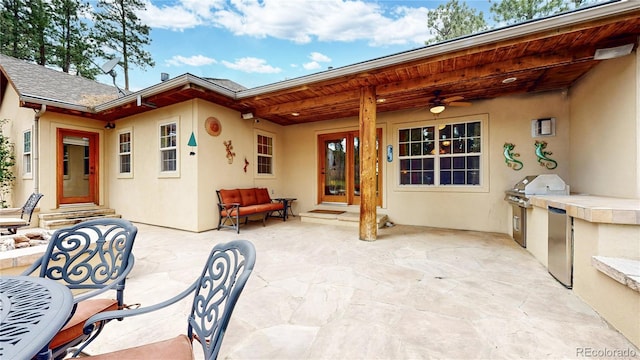 view of patio / terrace featuring ceiling fan and an outdoor kitchen