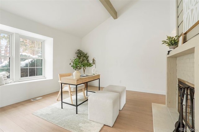 office area featuring beamed ceiling, high vaulted ceiling, and light wood-type flooring