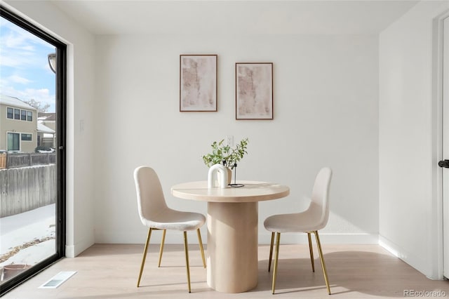 dining area with light hardwood / wood-style flooring