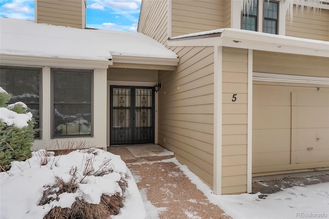 view of snow covered property entrance