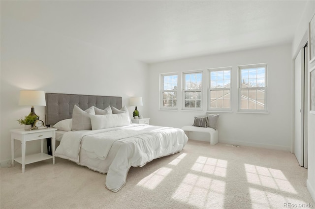 carpeted bedroom featuring multiple windows