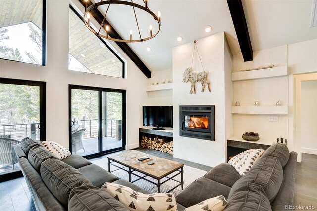 30298 San Isabel Rd, Buena Vista, CO 81211 - living area with a chandelier, beam ceiling, built in shelves, a glass covered fireplace, and recessed lighting
