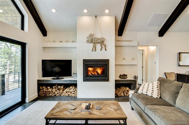 30298 San Isabel Rd, Buena Vista, CO 81211 - living room with beamed ceiling, a glass covered fireplace, recessed lighting, and baseboards