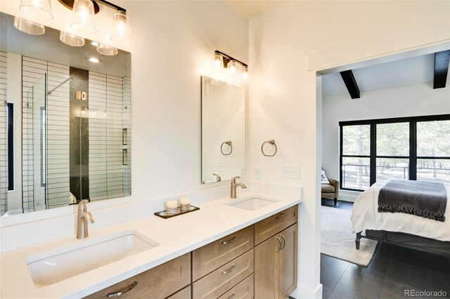 30298 San Isabel Rd, Buena Vista, CO 81211 - ensuite bathroom featuring double vanity, beamed ceiling, a stall shower, and wood finished floors