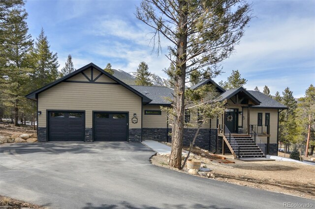 30298 San Isabel Rd, Buena Vista, CO 81211 - view of front of property featuring driveway, a garage, and stone siding