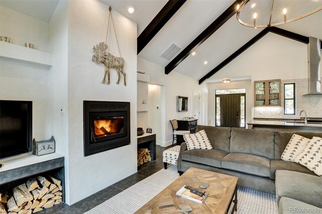 30298 San Isabel Rd, Buena Vista, CO 81211 - living room featuring high vaulted ceiling, a lit fireplace, beam ceiling, and a chandelier