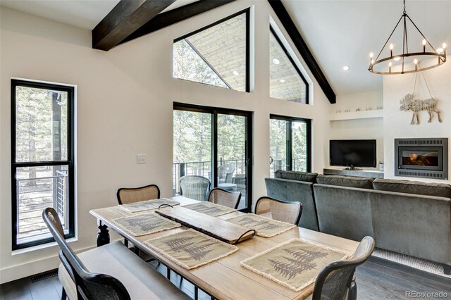 30298 San Isabel Rd, Buena Vista, CO 81211 - dining space featuring beam ceiling, a chandelier, wood finished floors, baseboards, and high vaulted ceiling