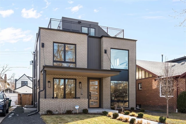 view of front of house with fence and brick siding