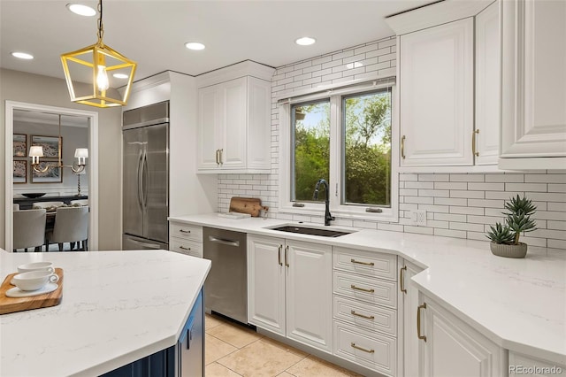 kitchen featuring a sink, appliances with stainless steel finishes, white cabinets, backsplash, and recessed lighting