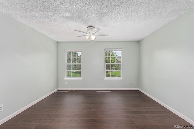 spare room featuring ceiling fan, a textured ceiling, dark wood finished floors, and baseboards