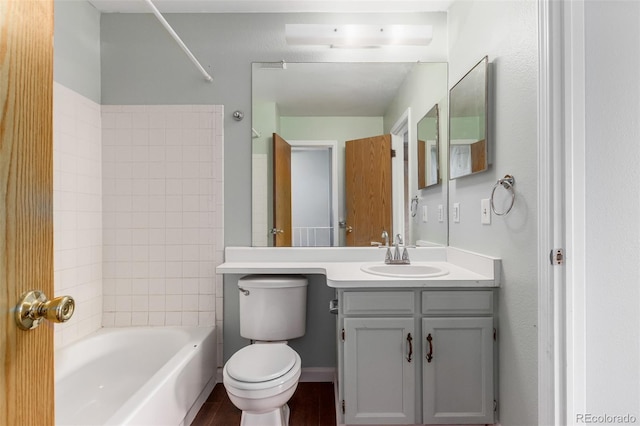 bathroom with toilet, shower / tub combination, vanity, and baseboards