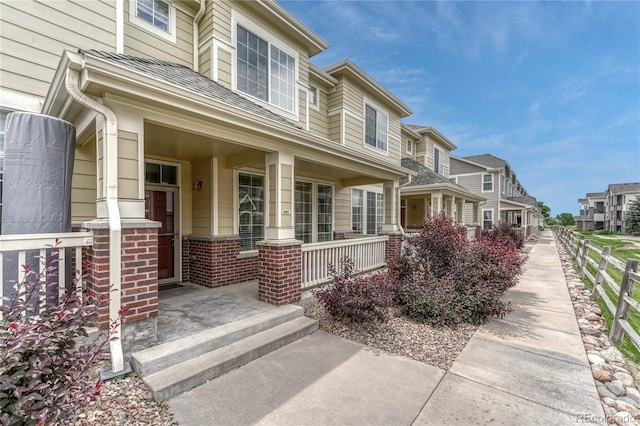 16051 E Geddes Dr Unit 66, Aurora, CO 80016 - view of front of house with covered porch, brick siding, and a residential view
