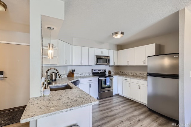 kitchen featuring light hardwood / wood-style floors, stainless steel appliances, and white cabinets