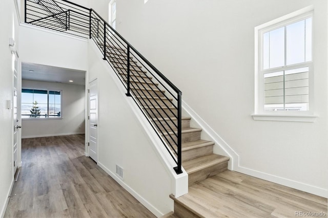 stairway featuring wood-type flooring