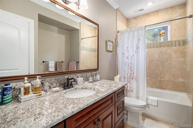 full bathroom featuring visible vents, toilet, shower / bath combo with shower curtain, and vanity
