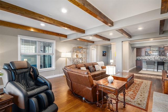 living area featuring wood finished floors, beamed ceiling, baseboards, and recessed lighting