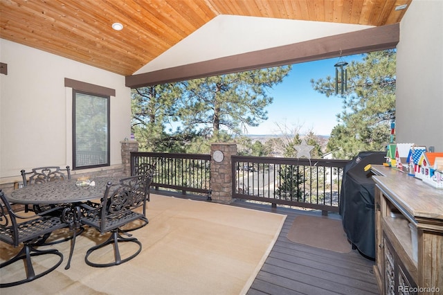 wooden deck featuring outdoor dining area