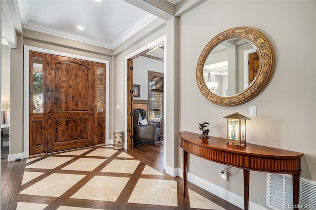 entryway featuring crown molding, baseboards, visible vents, and recessed lighting