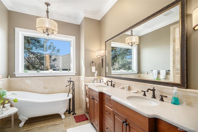 full bath featuring a freestanding tub, double vanity, ornamental molding, tile walls, and a sink