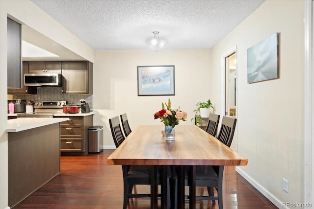 2306 S Troy St Unit A, Aurora, CO 80014 - dining area with dark wood finished floors, a textured ceiling, and baseboards