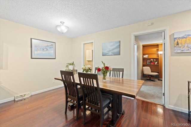2306 S Troy St Unit A, Aurora, CO 80014 - dining area with visible vents, baseboards, dark wood-style floors, and a textured ceiling