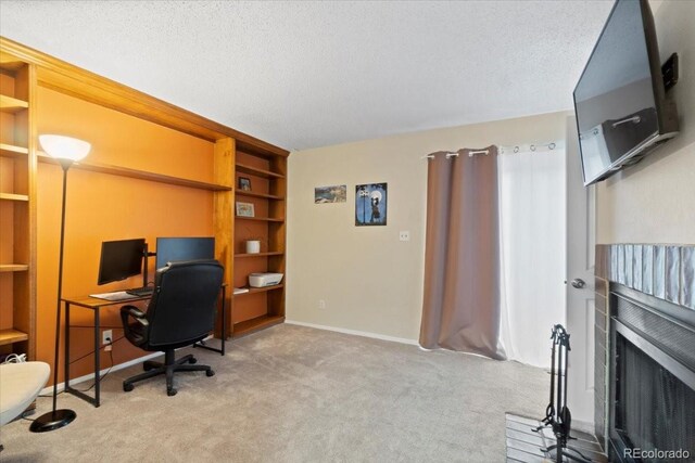 2306 S Troy St Unit A, Aurora, CO 80014 - office area featuring baseboards, carpet flooring, a textured ceiling, and built in shelves