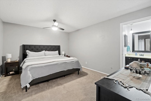 2306 S Troy St Unit A, Aurora, CO 80014 - bedroom featuring ensuite bath, light carpet, a ceiling fan, and baseboards