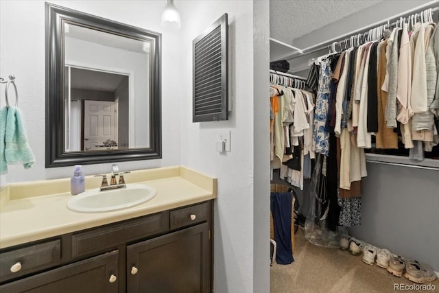 2306 S Troy St Unit A, Aurora, CO 80014 - bathroom with a walk in closet and vanity