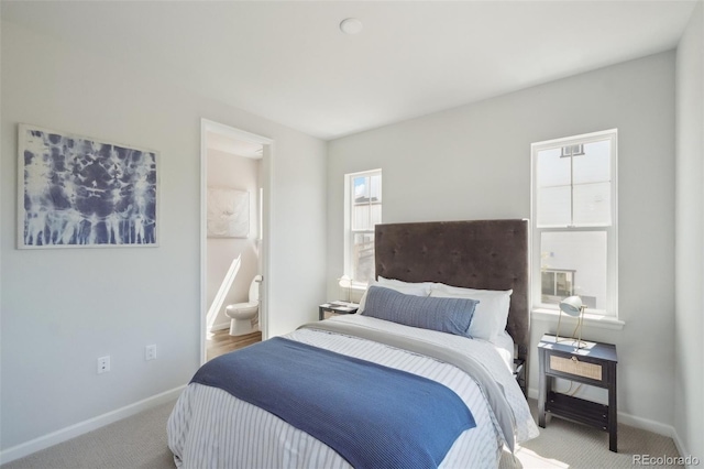 bedroom featuring carpet flooring, baseboards, and connected bathroom