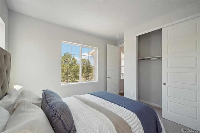 bedroom featuring a closet, baseboards, and carpet floors