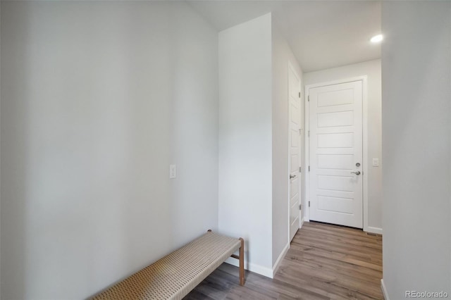 hallway with wood finished floors and baseboards