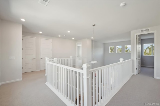 corridor with recessed lighting, carpet, visible vents, and baseboards