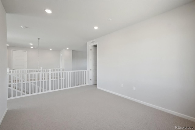 spare room featuring recessed lighting, baseboards, and carpet floors