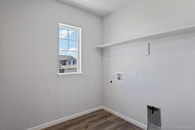 clothes washing area with dark wood finished floors, baseboards, hookup for an electric dryer, hookup for a washing machine, and laundry area