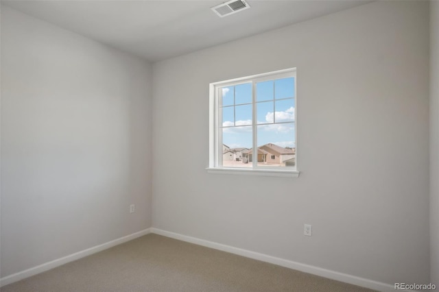 carpeted empty room with visible vents and baseboards