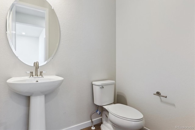 13900 Hanging Lake St, Parker, CO 80138 - half bath with baseboards, toilet, and a sink