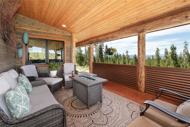 sunroom featuring vaulted ceiling and wood ceiling