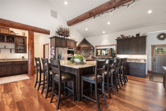 dining area with dark hardwood / wood-style flooring and vaulted ceiling