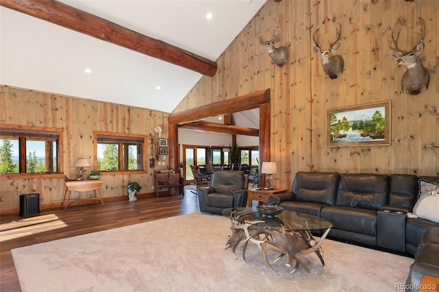 unfurnished living room with beam ceiling, dark hardwood / wood-style floors, and high vaulted ceiling