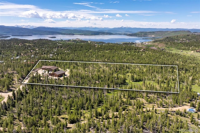 birds eye view of property with a water and mountain view