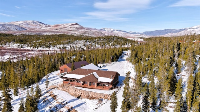 snowy aerial view featuring a mountain view