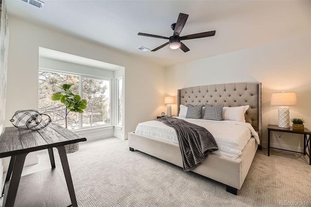 bedroom featuring ceiling fan and light carpet