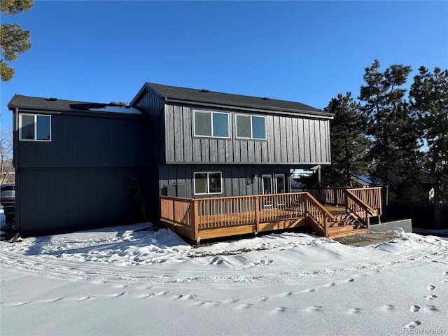 snow covered property with a wooden deck