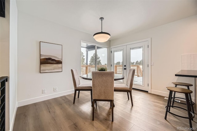 dining space featuring french doors and hardwood / wood-style floors