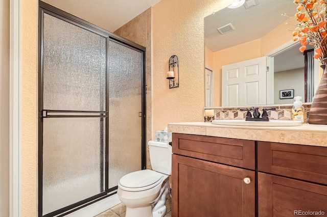 15056 Fillmore Way, Thornton, CO 80602 - bathroom with a textured wall, vanity, a stall shower, and tile patterned flooring