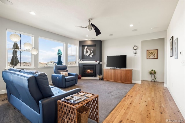 living room featuring ceiling fan and hardwood / wood-style flooring